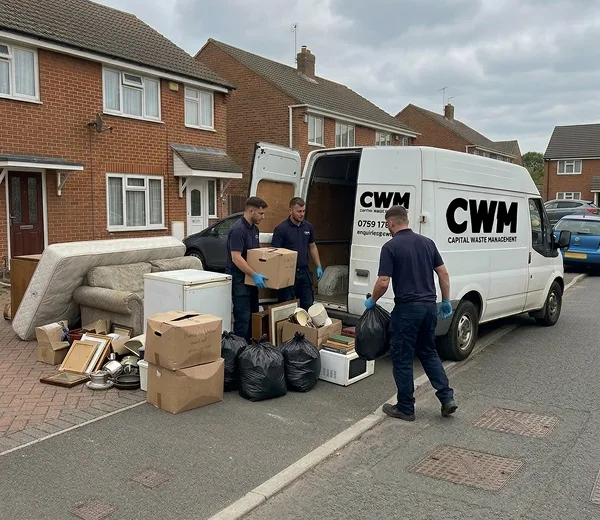 CWM team: two crew in branded uniforms by the van.